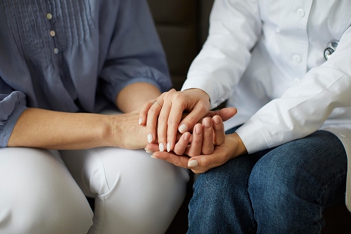 covid-recovery-center-female-doctor-holding-elder-patient-s-hands 1